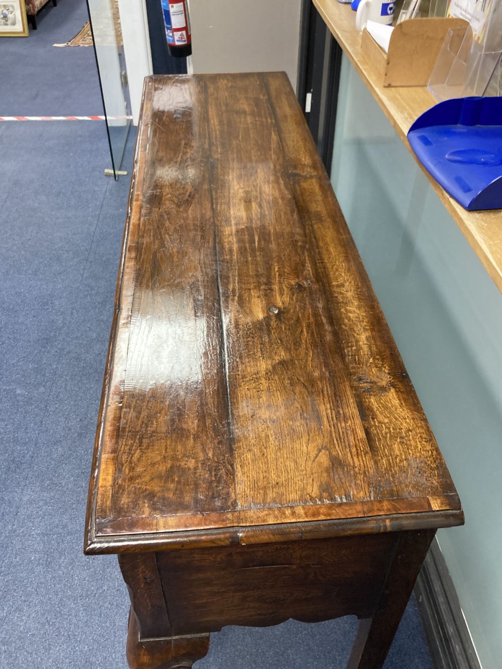 A reproduction mid 18th century oak and mahogany crossbanded dresser, fitted three small drawers, raised on cabriole legs